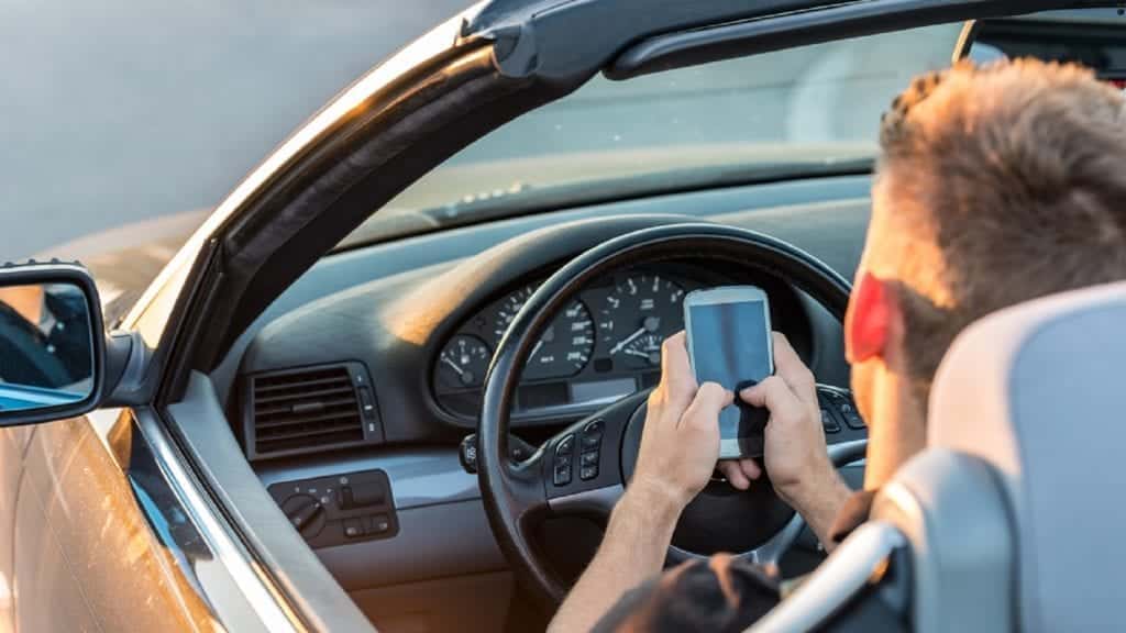 Young Man Texting While Driving Stock Photo
