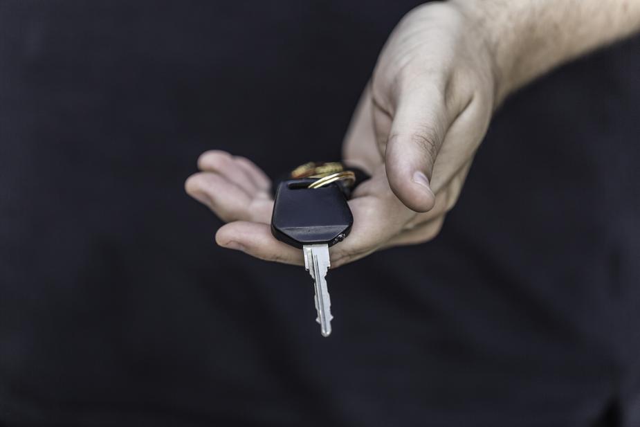 new driver holding key to a car