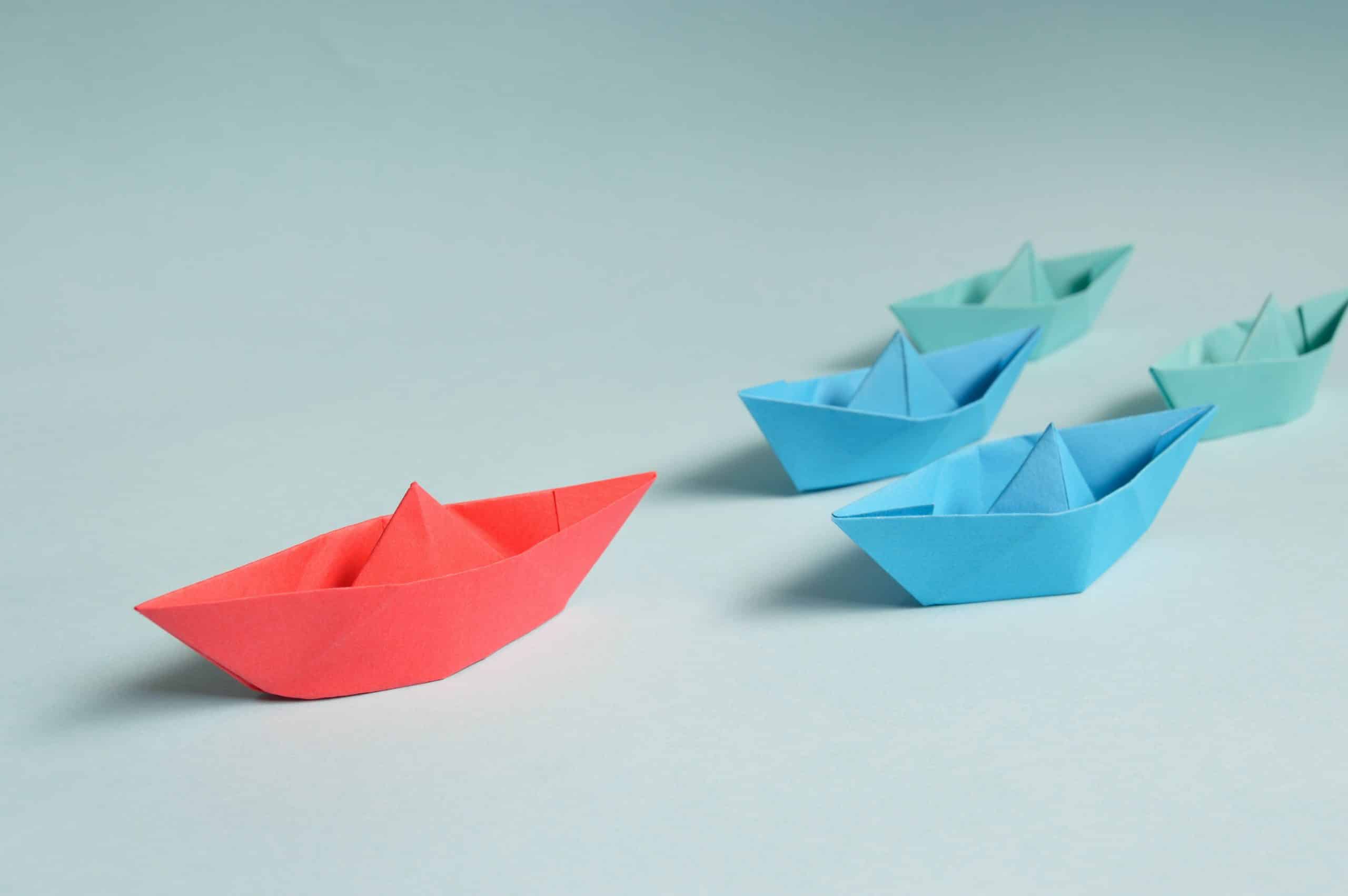 Red blue and green paper boats.
